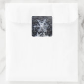 A single snowflake on stands out square sticker (Bag)