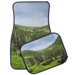 A small pond in the valley of the mountains in the car floor mat