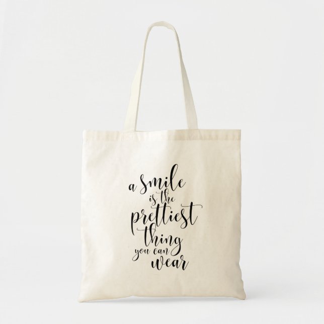 A smile is the prettiest thing you can wear tote bag (Front)