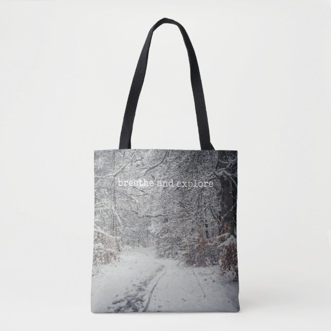 A snow-covered path through a winter forest tote bag (Front)