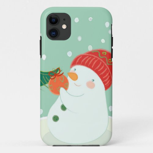 A snowman hanging an ornament on a tree iPhone 11 case