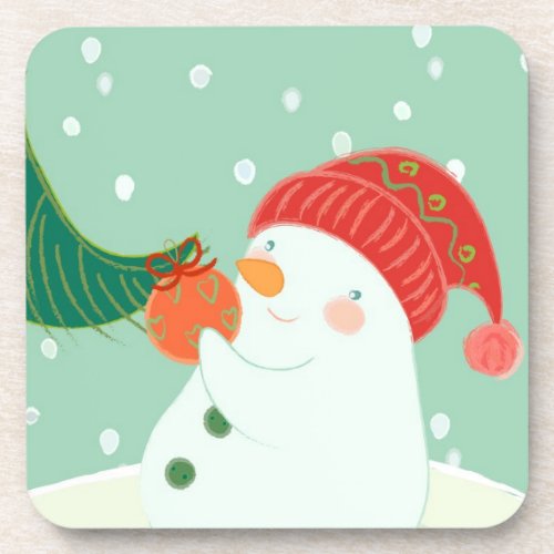 A snowman hanging an ornament on a tree coaster
