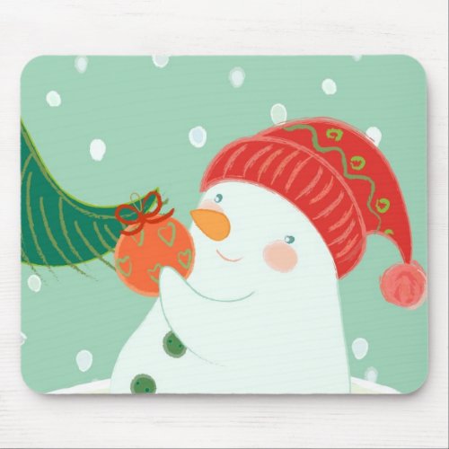 A snowman hanging an ornament on a tree mouse pad