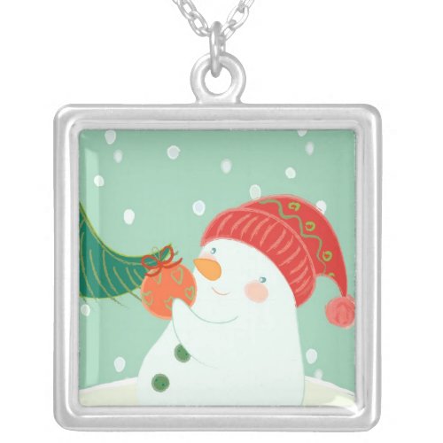 A snowman hanging an ornament on a tree silver plated necklace