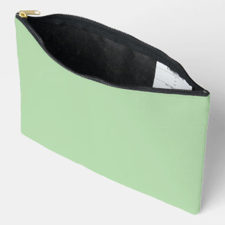 A soft pale green background fills the image accessory pouch