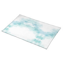 A soft white placemat with a delicate turquoise