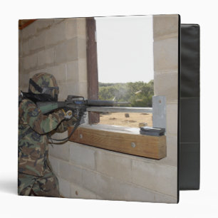 A soldier acts as an opposition force 3 ring binder