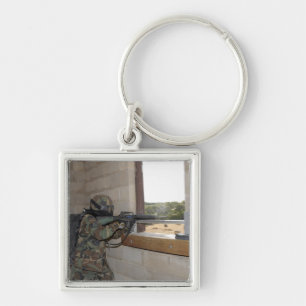 A soldier acts as an opposition force keychain