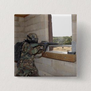 A soldier acts as an opposition force pinback button
