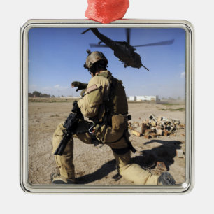 A soldier conducts security for an HH-60 Metal Ornament
