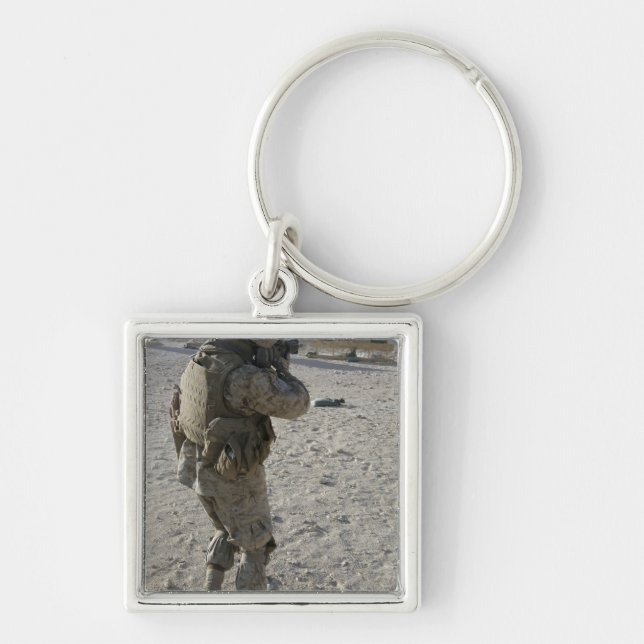 A soldier engages his target on a shooting rang keychain (Front)