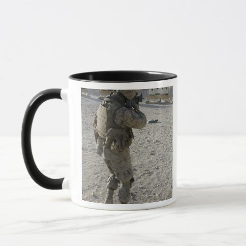 A soldier engages his target on a shooting rang mug