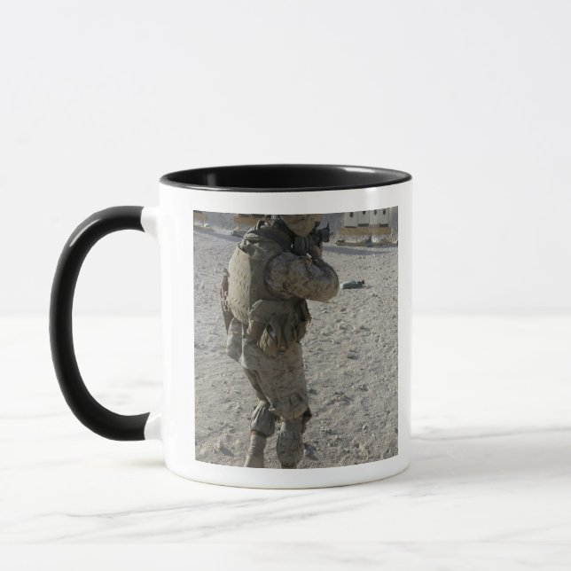 A soldier engages his target on a shooting rang mug (Left)
