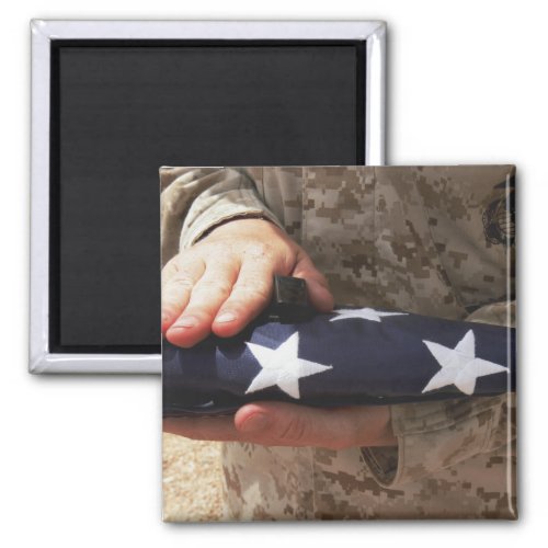 A soldier holds the United States flag Magnet