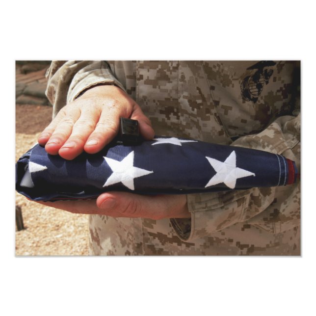 A soldier holds the United States flag Photo Print (Front)
