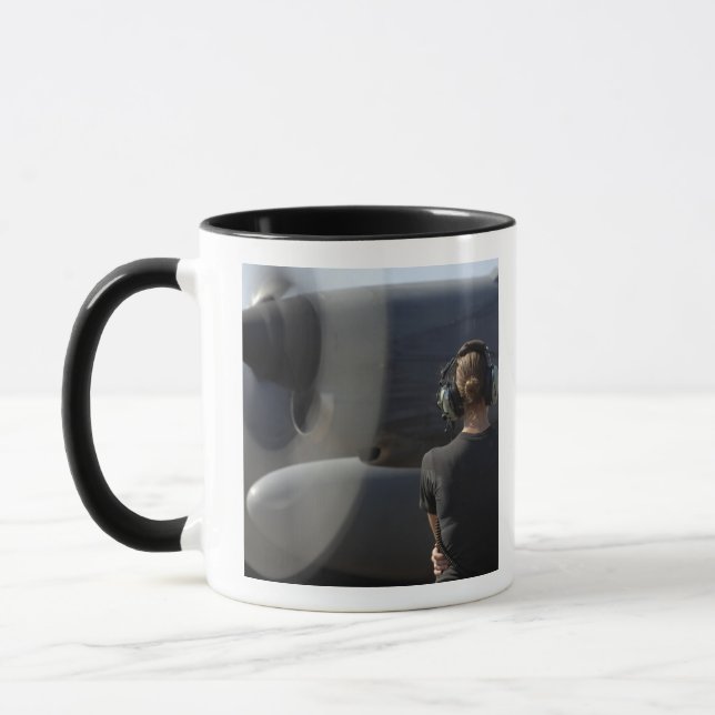 A soldier monitors the performance mug (Left)