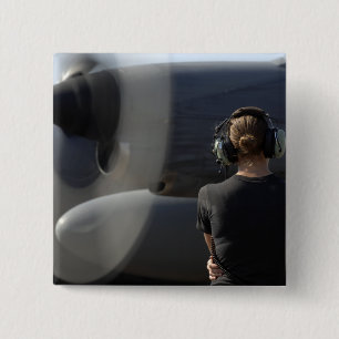 A soldier monitors the performance pinback button