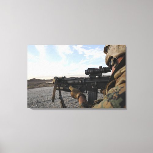 A soldier sights in to fire on a target canvas print