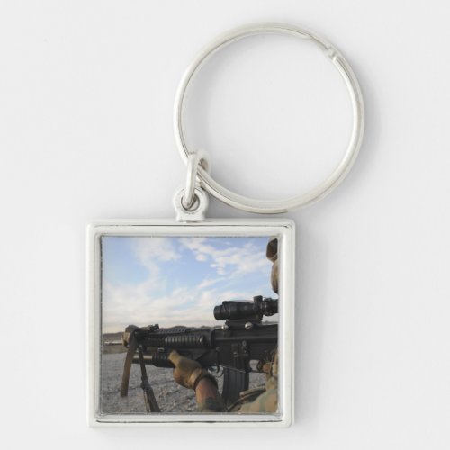 A soldier sights in to fire on a target keychain