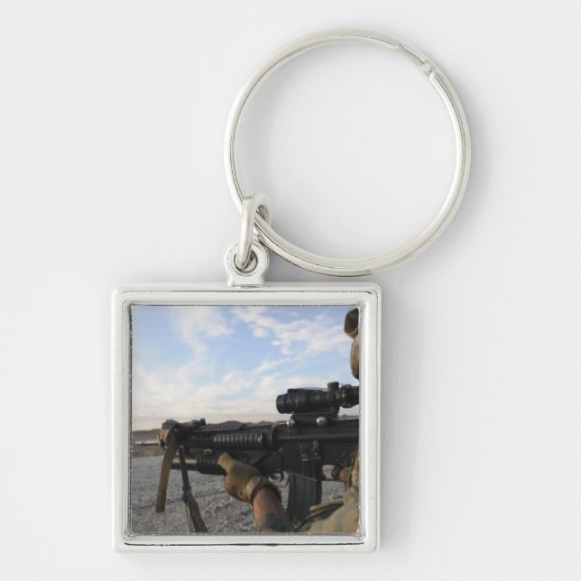 A soldier sights in to fire on a target keychain (Front)