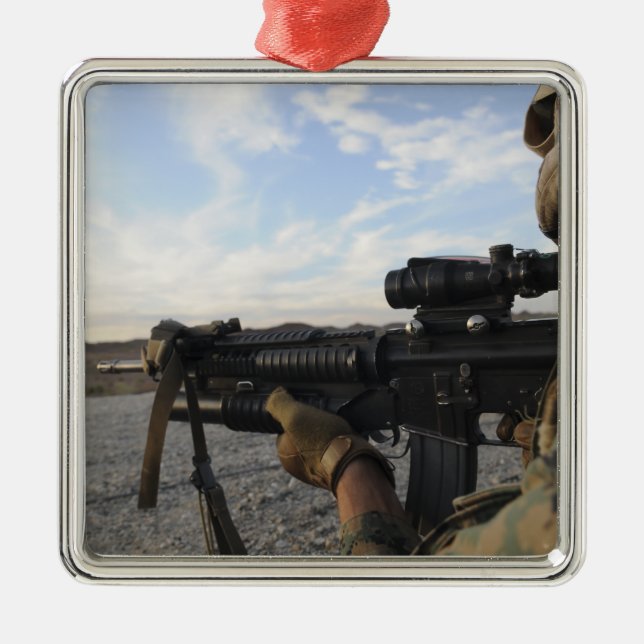 A soldier sights in to fire on a target metal ornament (Front)