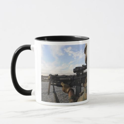 A soldier sights in to fire on a target mug