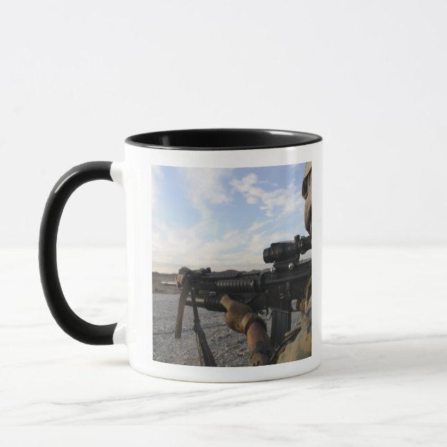 A soldier sights in to fire on a target mug (Left)