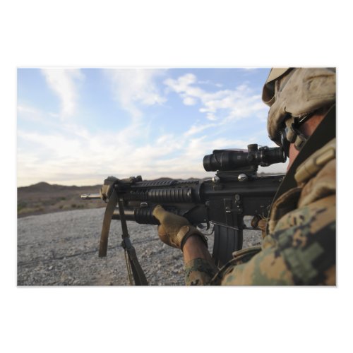 A soldier sights in to fire on a target photo print