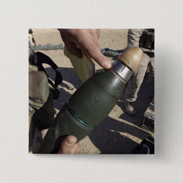 A squad leader points to a delay setting button (Front)