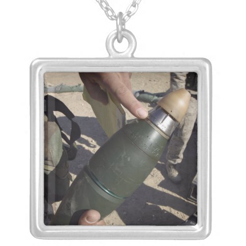 A squad leader points to a delay setting silver plated necklace