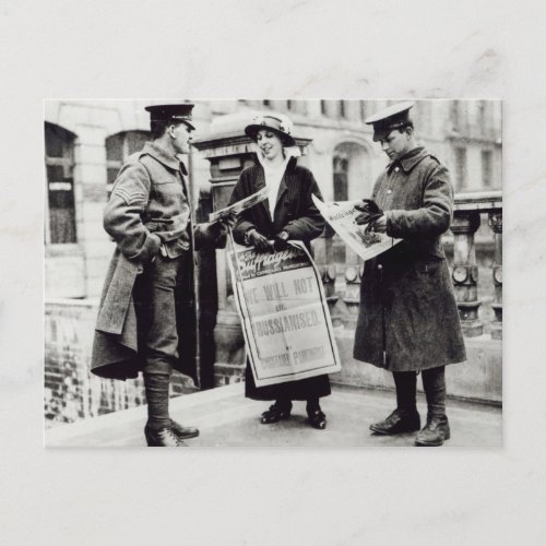 A Suffragette selling newspapers to two Postcard