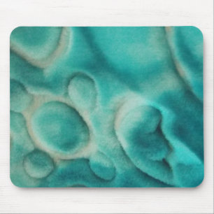 A swirling pattern in teal and light beige mouse pad