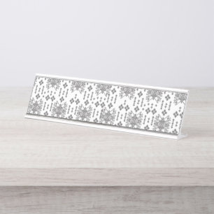 A symmetrical monochrome design featuring intricat desk name plate