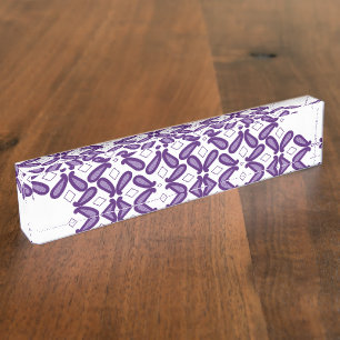 A symmetrical pattern featuring white and purple m desk name plate