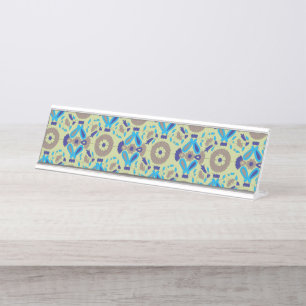 A symmetrical textile design featuring blue and or desk name plate