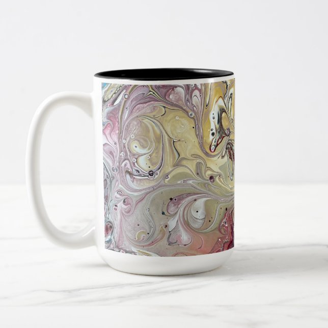 A teal and pink coffee mug (Left)