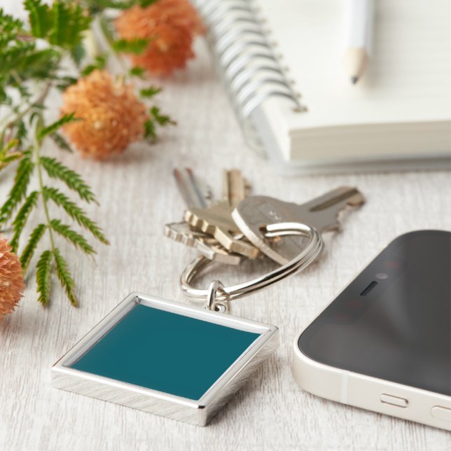 A teal blue textured background fills the image keychain (Side)