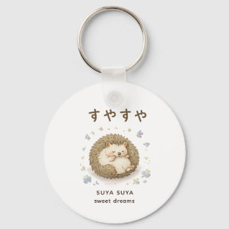 A tiny hedgehog enjoying a peaceful nap keychain