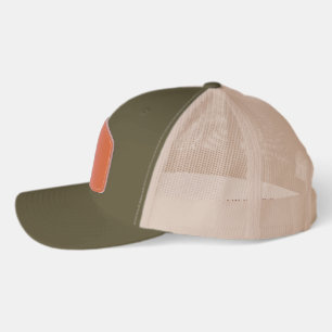 A trucker hat with a green front and beige mesh