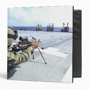 A US Marine adjusting his weapon 3 Ring Binder