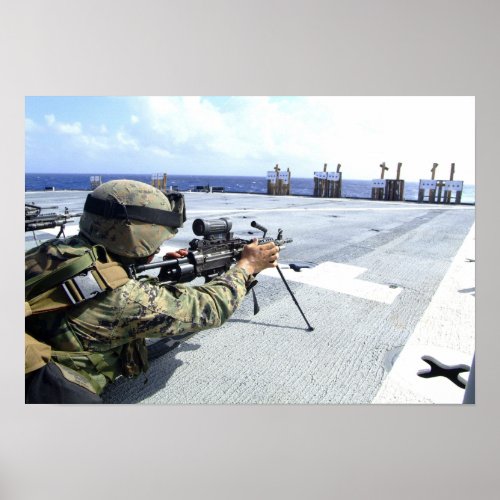 A US Marine adjusting his weapon Poster