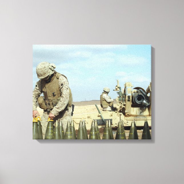 A US Marine prepares howitzer rounds to be fire Canvas Print (Front)
