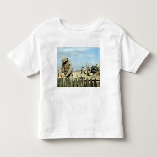 A US Marine prepares howitzer rounds to be fire Toddler T_shirt