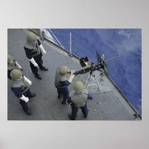 A US Sailor fires a 50_caliber M2HB Poster