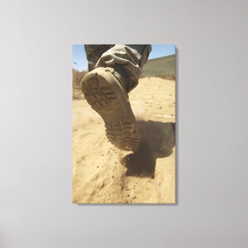 A US soldier walks along a dirt path Canvas Print