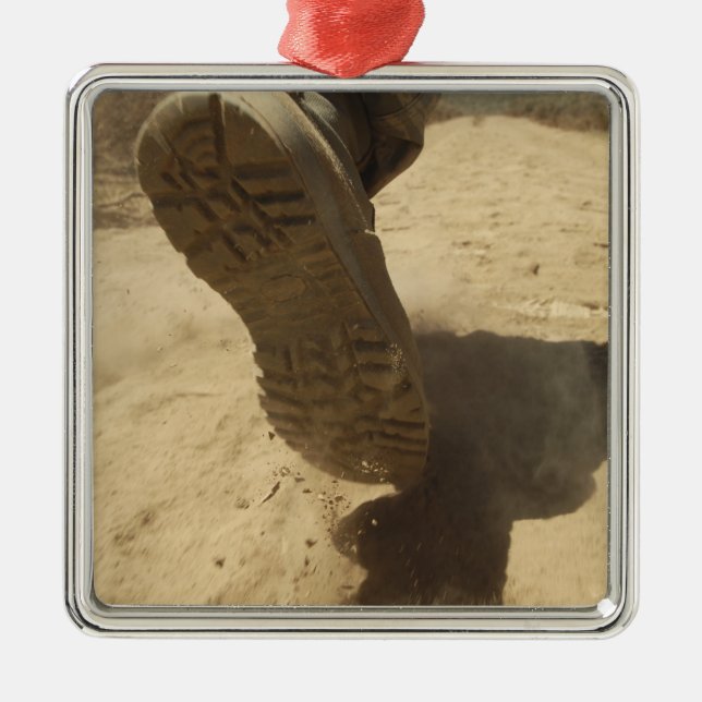 A US soldier walks along a dirt path Metal Ornament (Front)