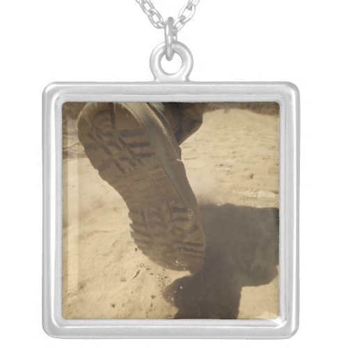 A US soldier walks along a dirt path Silver Plated Necklace