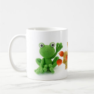 A very green crochet frog coat coffee mug