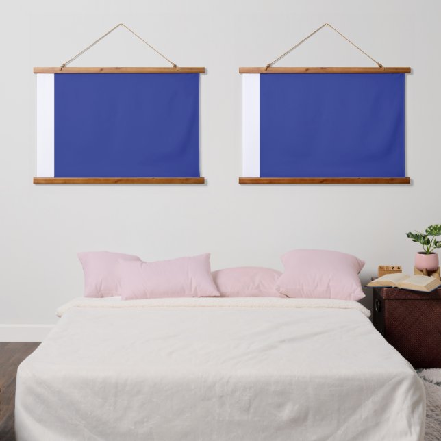 A vibrant blue backdrop with a clean white square  hanging tapestry (Bedroom)