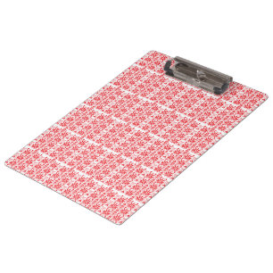 A vibrant red rose with dewdrops gently resting on clipboard